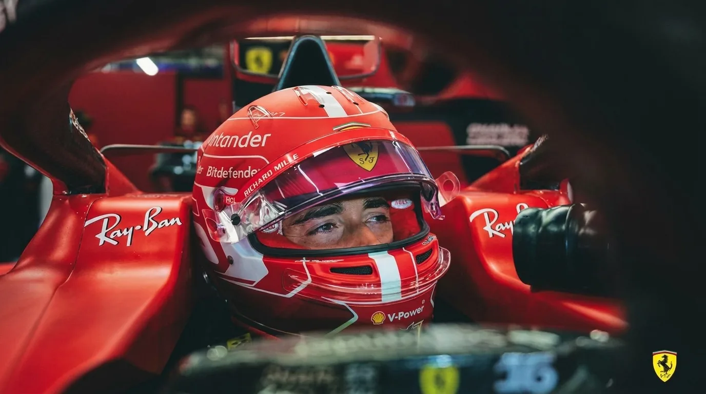 Charles Leclerc Ferrari driver holding contract extension signing with red Ferrari F1 car and Scuderia Ferrari logo visible in background