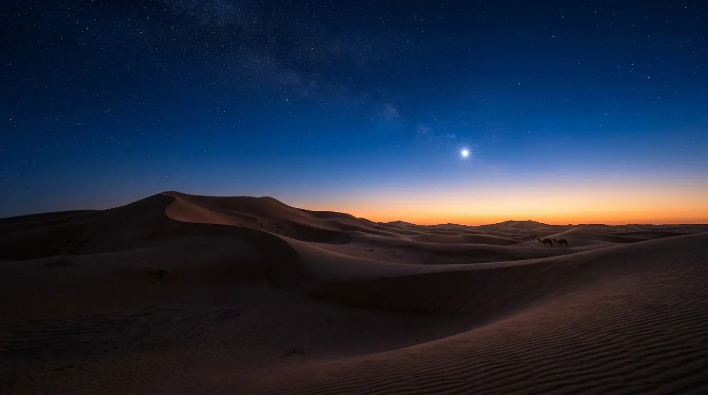 A bright star shines in a dark blue dawn sky above a silhouetted desert landscape with sand dunes.