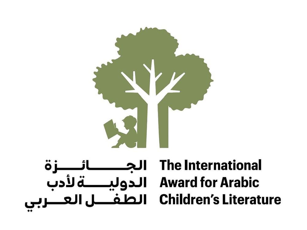A stack of colorful Arabic children’s books sits on a wooden table, representing a record increase in entries.