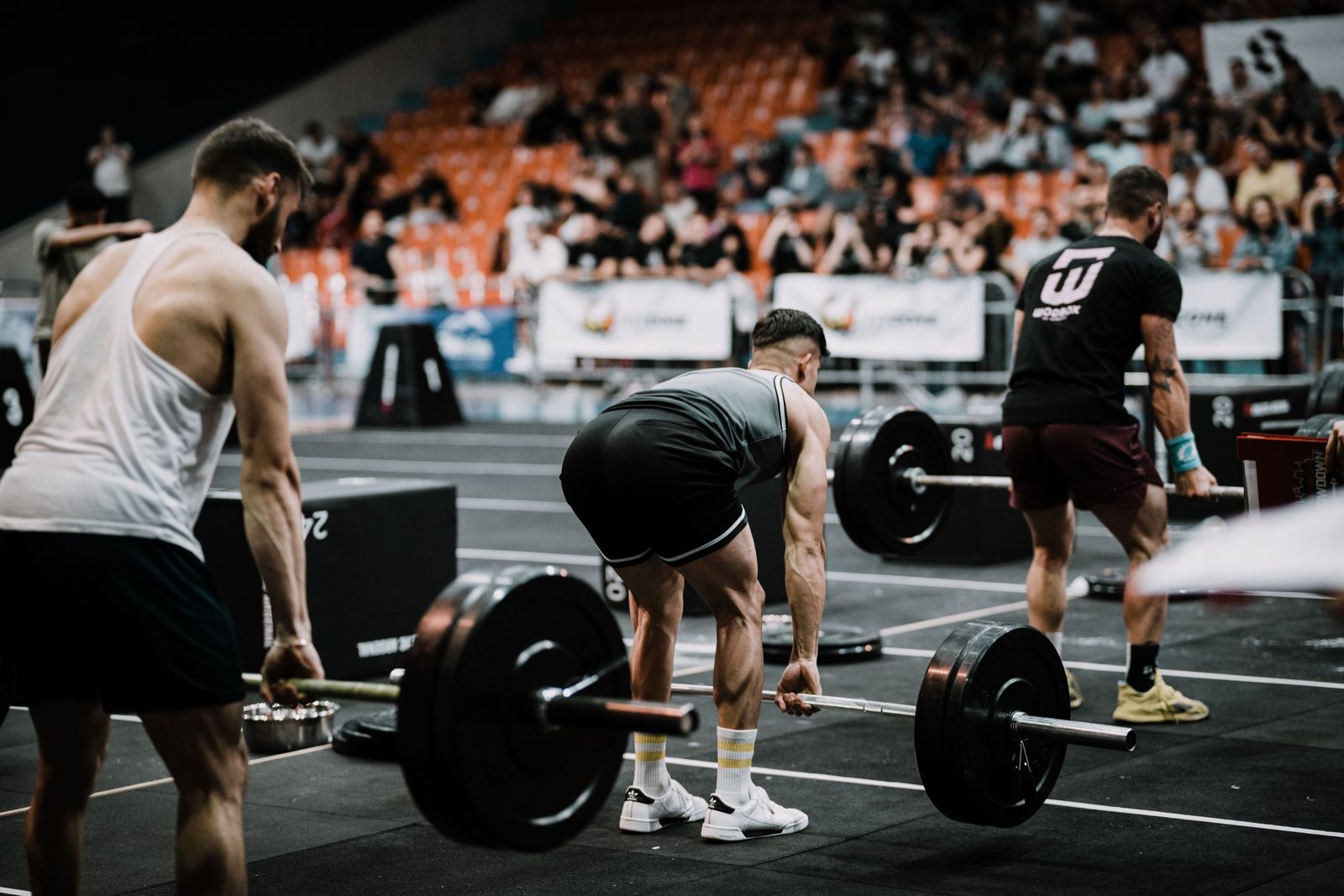 Athletes train in a modern facility while digital data overlays and tracking graphics monitor their movements.