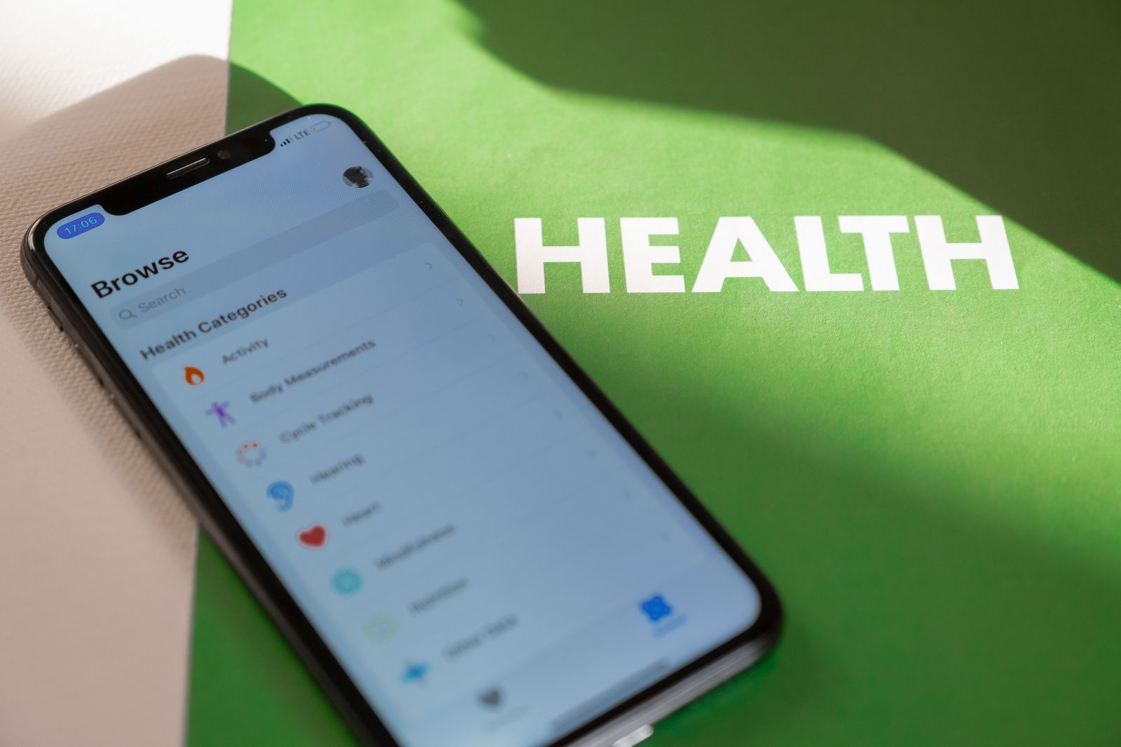 A person uses a smartphone to access a medical dashboard displaying digital health records and wellness data.