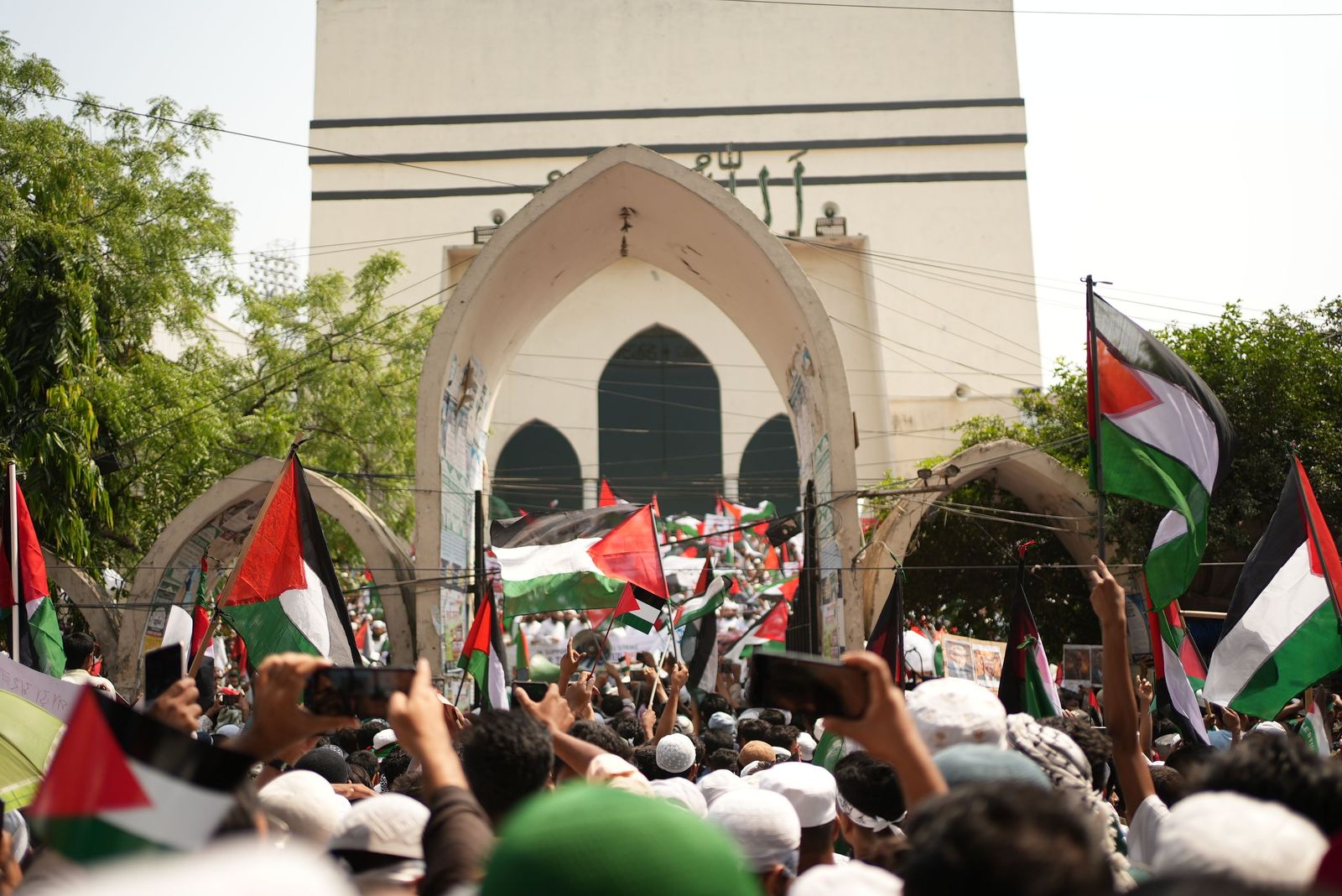 A large crowd gathers at Expo City Dubai outdoors to celebrate Palestinian heritage and culture during a festive event.