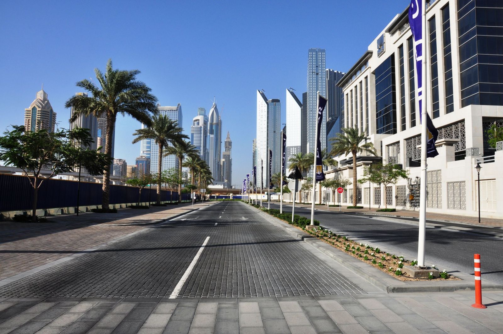 Modern Dubai skyline featuring sleek skyscrapers under a clear sky representing new construction technology regulations.