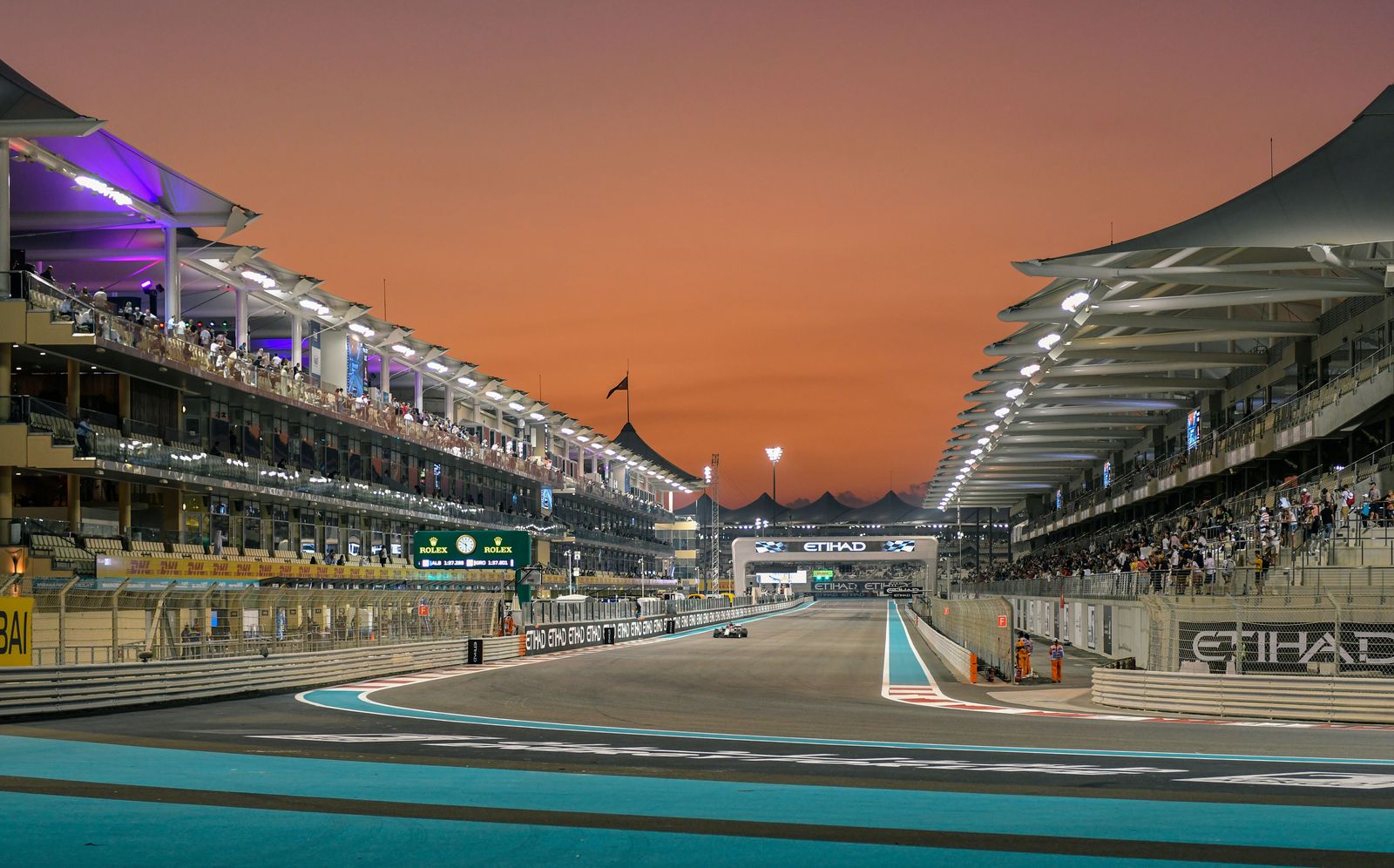 A split montage features a speeding Formula 1 car, a professional soccer match, and a tennis player serving on a blue court.