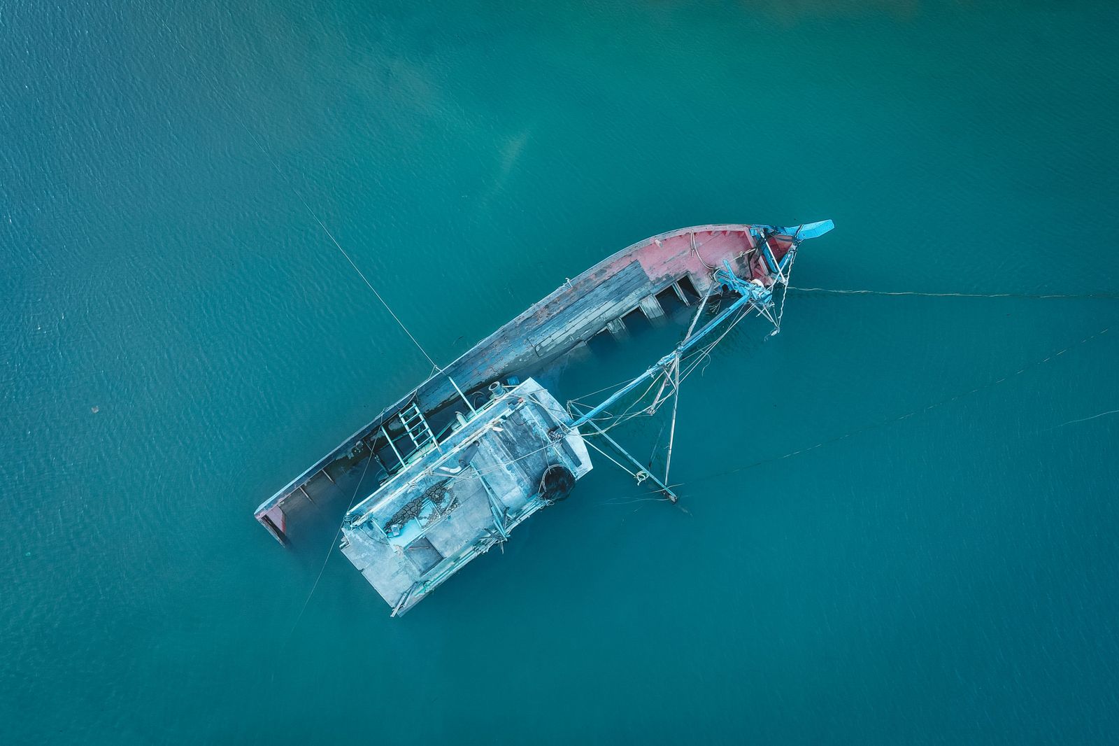 A yellow REMUS 600 autonomous underwater vehicle sits on a launch cradle before deployment into the ocean.