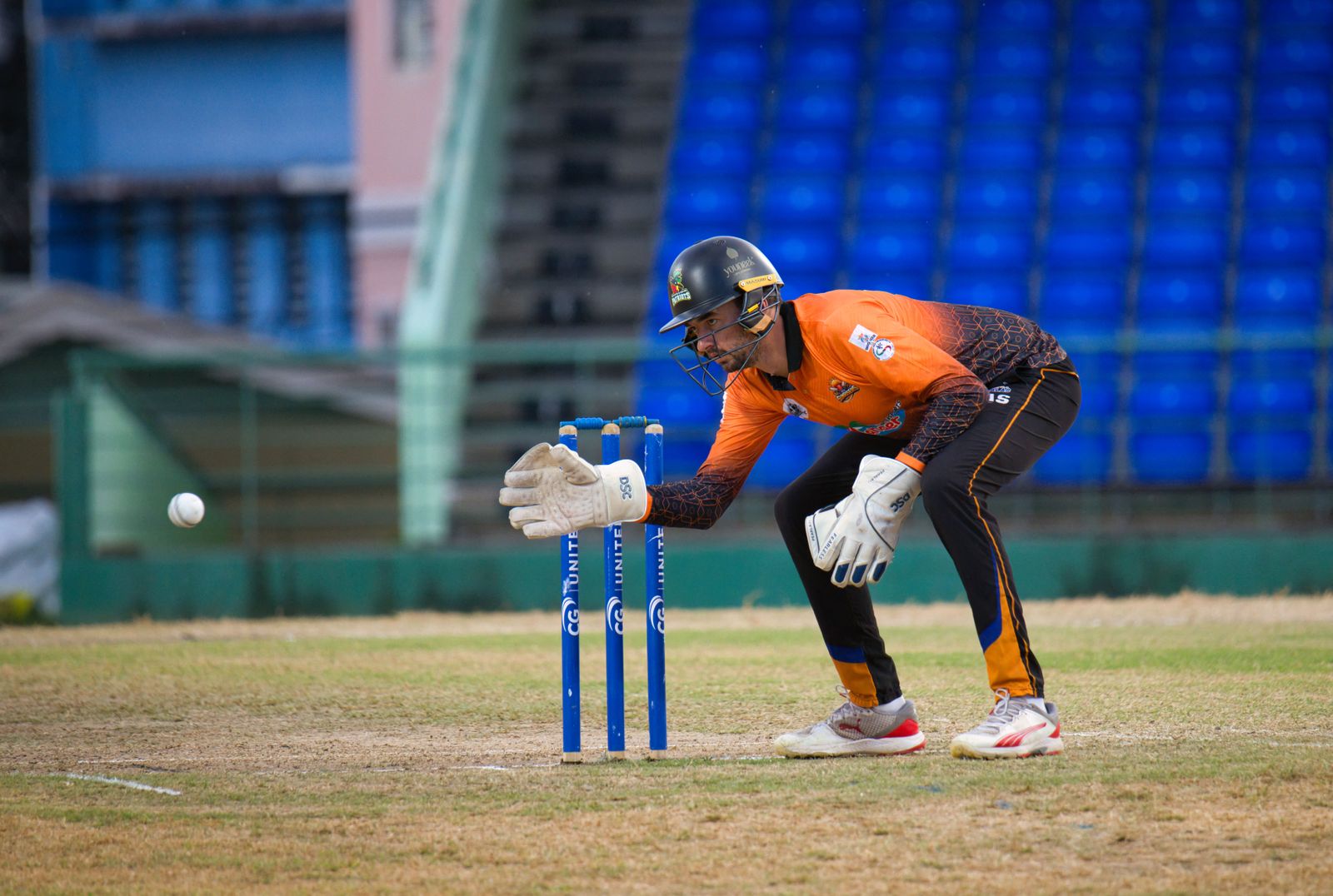 Cricketer Fazalhaq Farooqi bowls a delivery in his blue MI Emirates jersey during a professional T20 match.