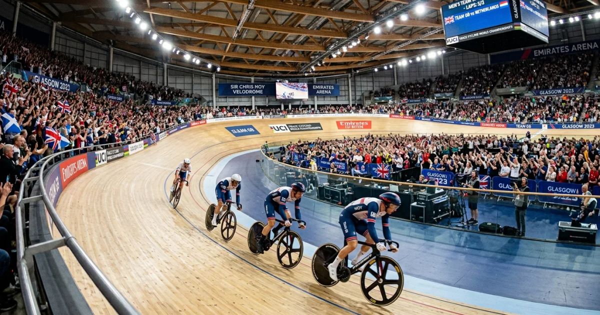 A modern athletic track in Glasgow's stadium glows under bright floodlights during a major sporting competition.